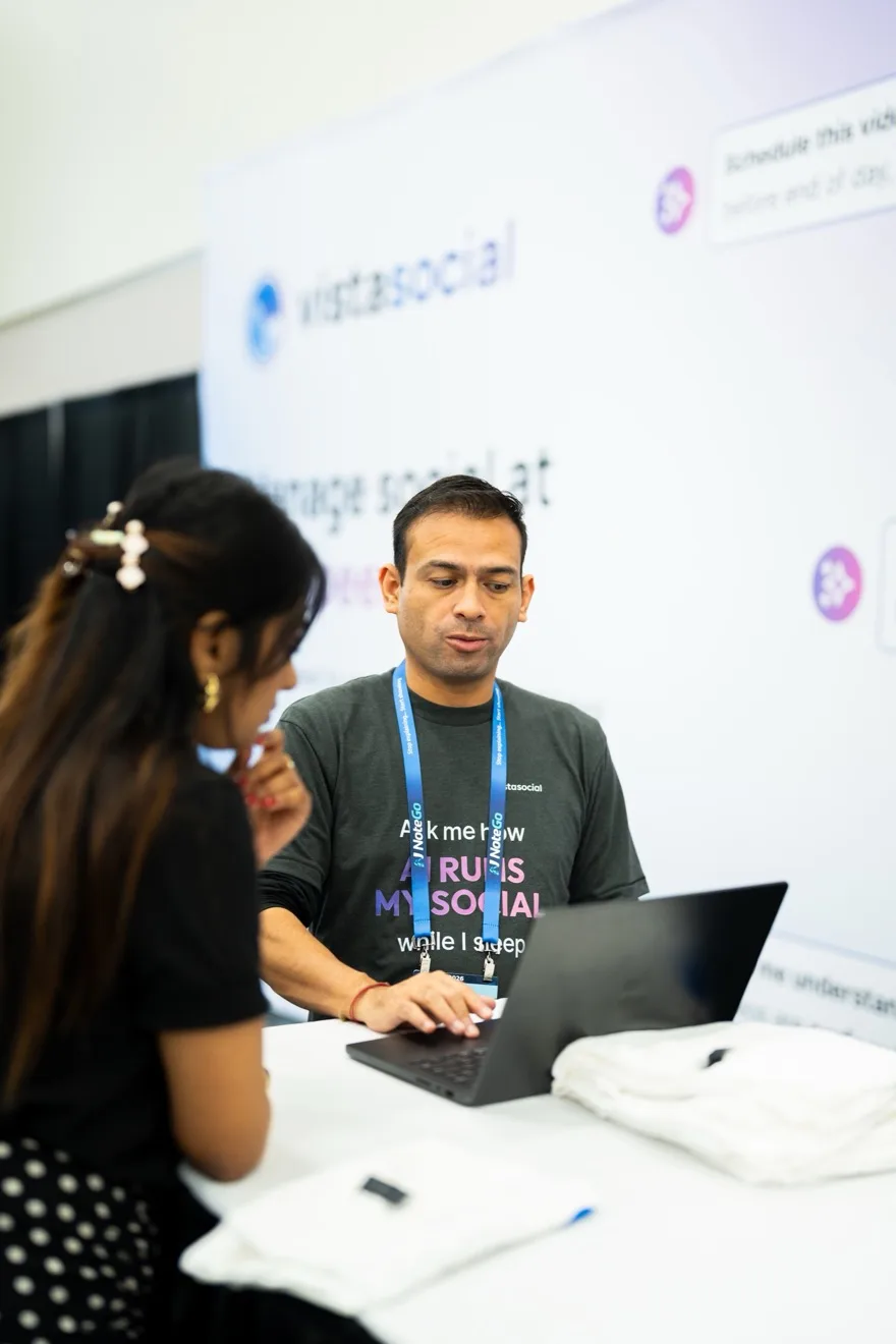 A Vista Social team member helping a customer at a conference booth